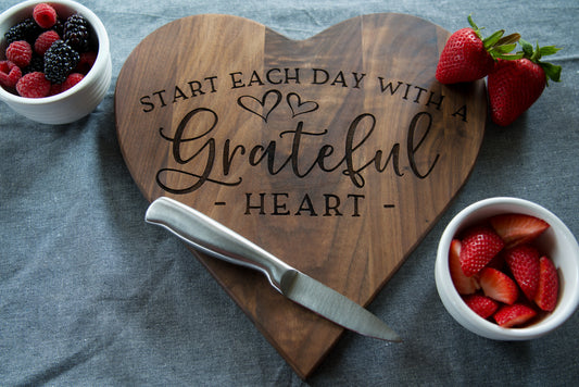 Engraved "Start each day with a grateful heart" cutting board on walnut.