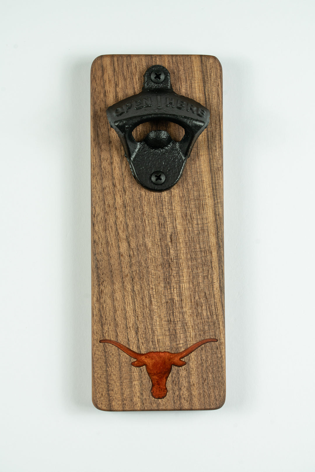 Walnut bottle opener with a Texas Longhorns design on a white background