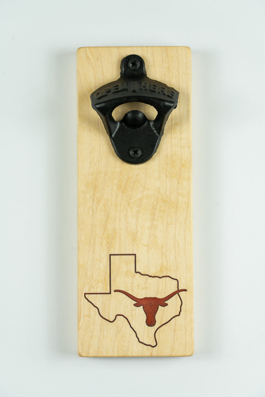 Wooden bottle opener with Texas Longhorns logo on a light background